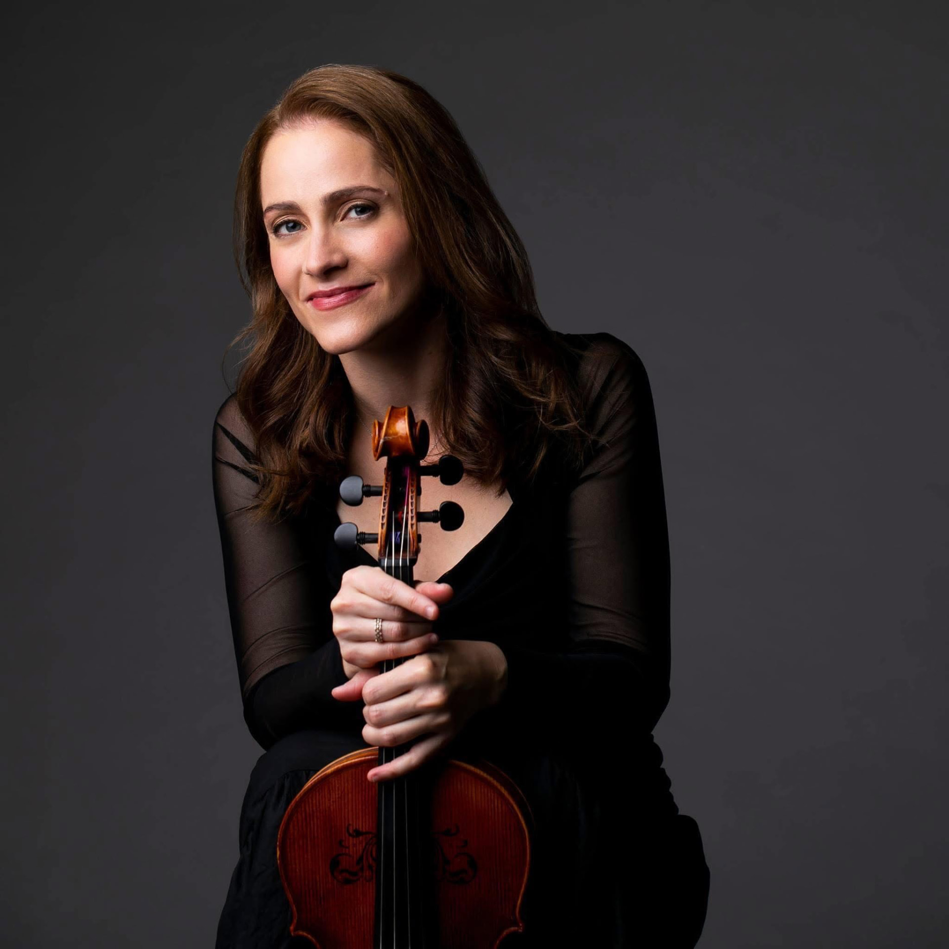 Portrait of violist Erina Goldwasser holding her viola